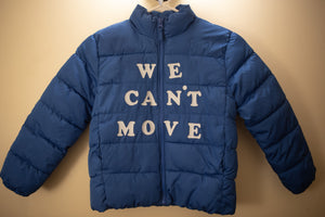 Puffy, blue children's jacket with white, vinyl letters that read, 